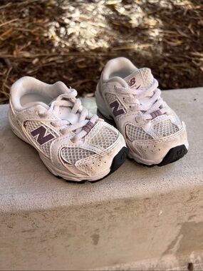 White and purple New Balance sneakers